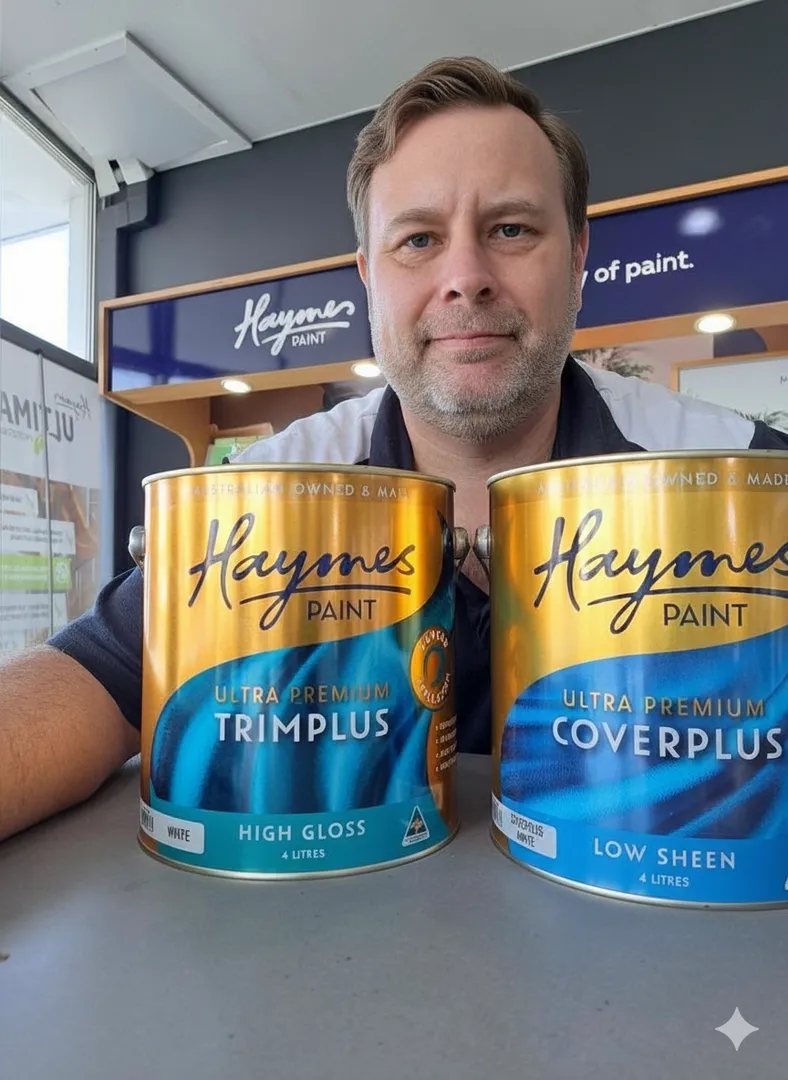 Person with Haymes Paint cans in store