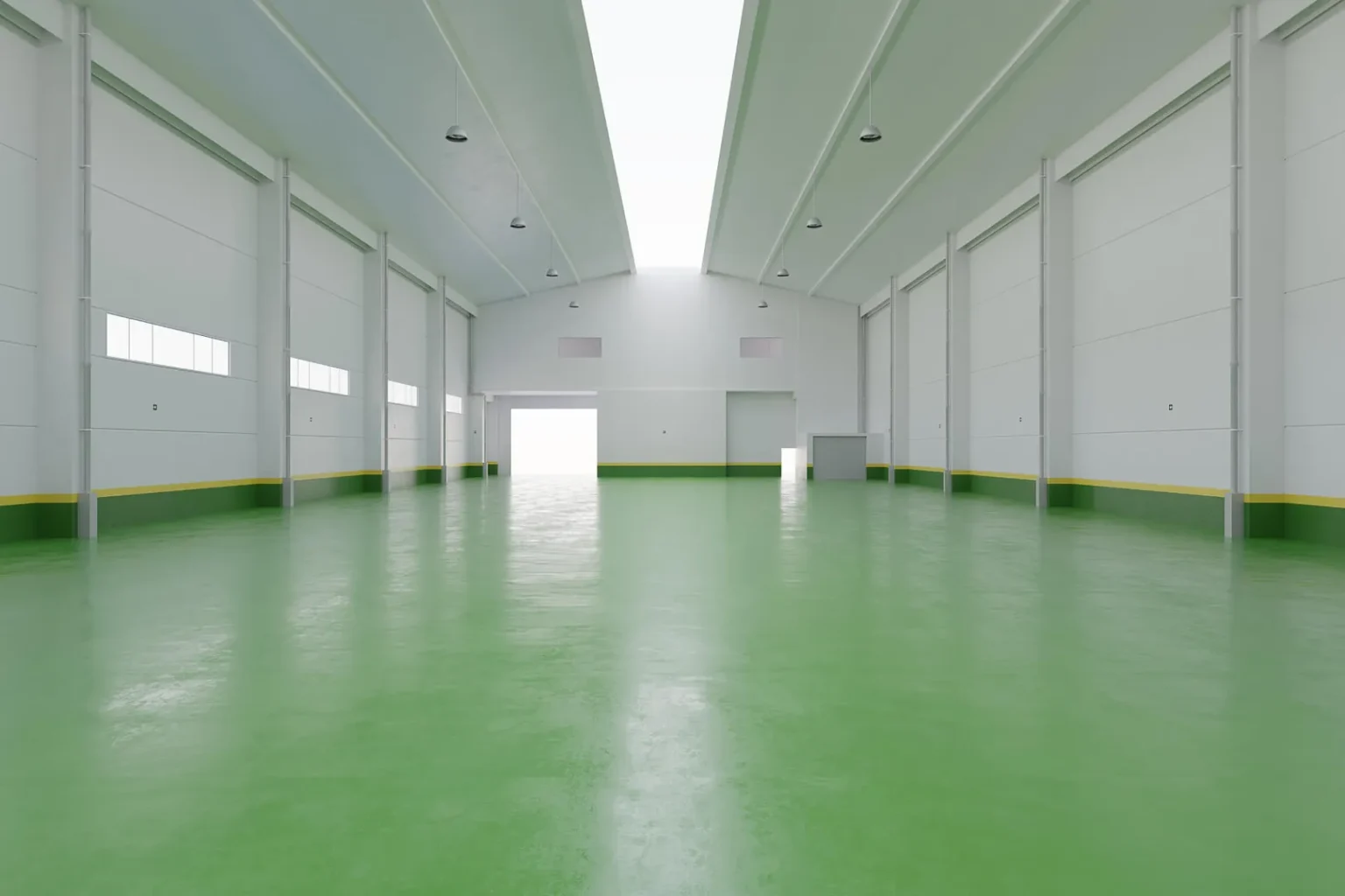 Spacious warehouse with green flooring and high ceiling.